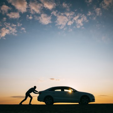 extended car warranty car breakdown guy pushing car sunset outdoor nature background